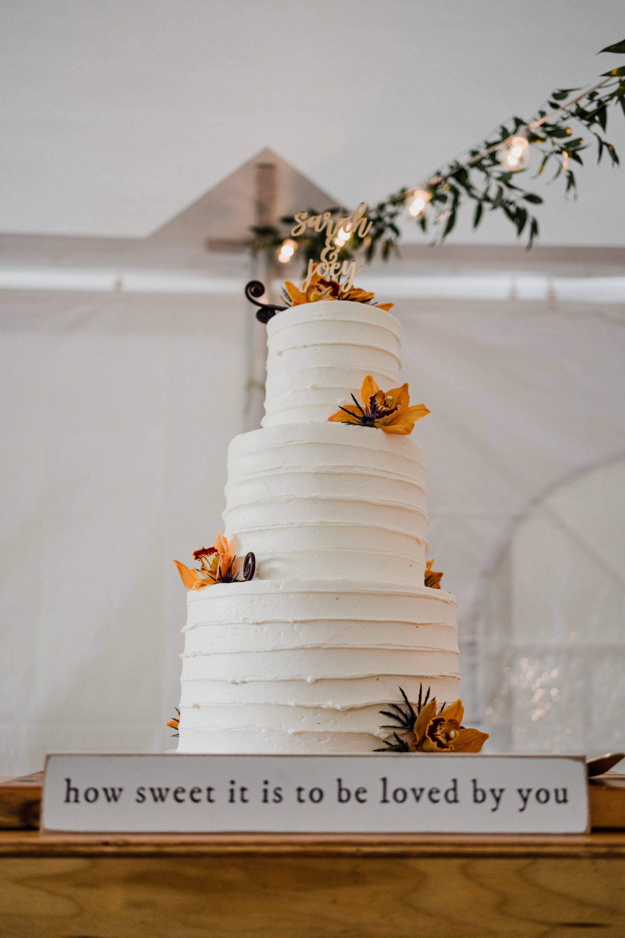 white 4 tier cake with yellow flowers on top